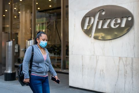 People walk by the Pfizer headquarters on Nov. 9, in New York City. 