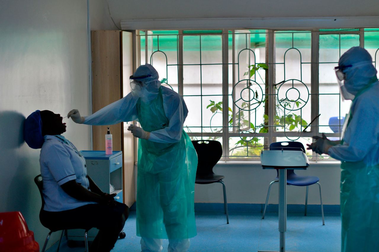 Laboratory staff obtain a sample from a resident nurse to test for COVID-19 at the Nairobi West Hospital in Kenya, on April 28.