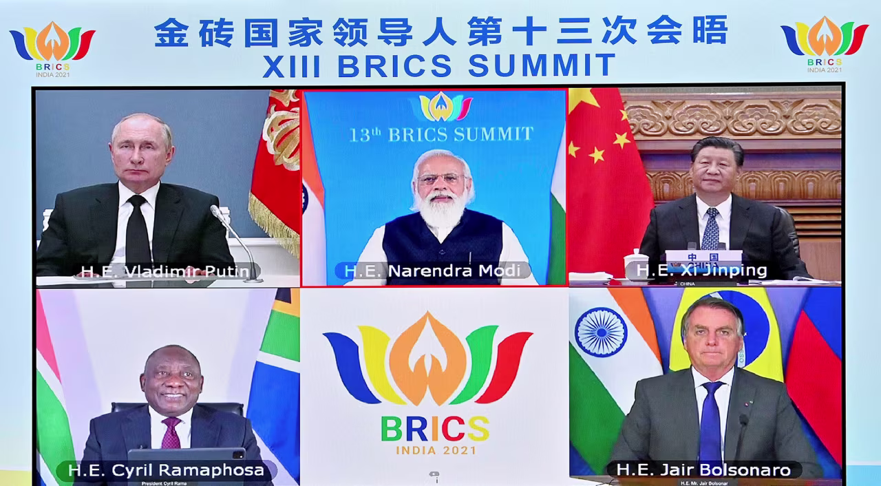 Russian President Vladimir Putin, top left, along with Chinese President Xi, South African President Cyril Ramaphosa, Brazilian President Jair Bolsonaro and the host, Indian Prime Minister Narendra Modi, attend the 13th BRICS summit via video link on September 9, 2021. 
