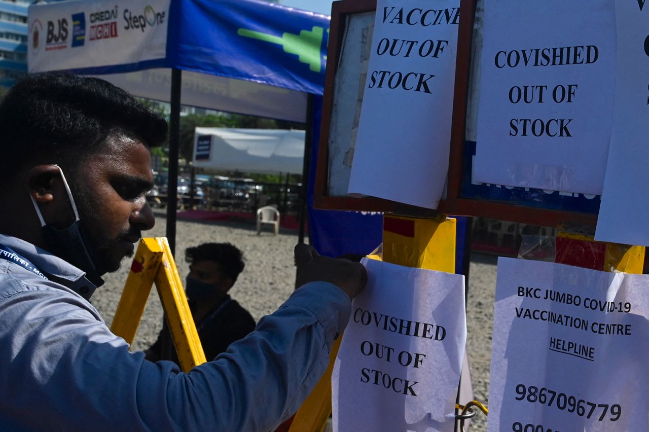 A staff tapes a notice at a vaccination center in Mumbai on April 20.