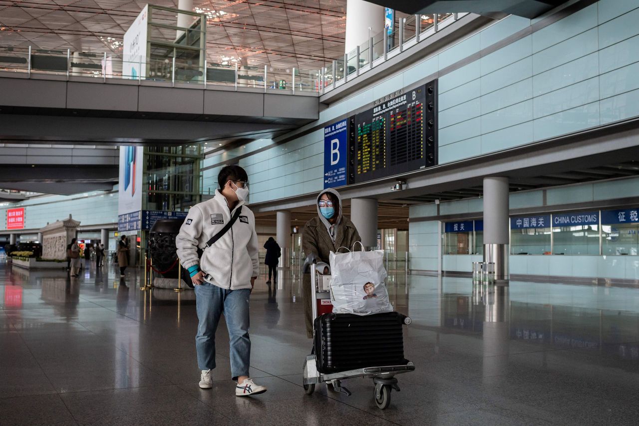 Passengers walk through a nearly empty arrivals area at Beijing Capital Airport in Beijing on March 16.