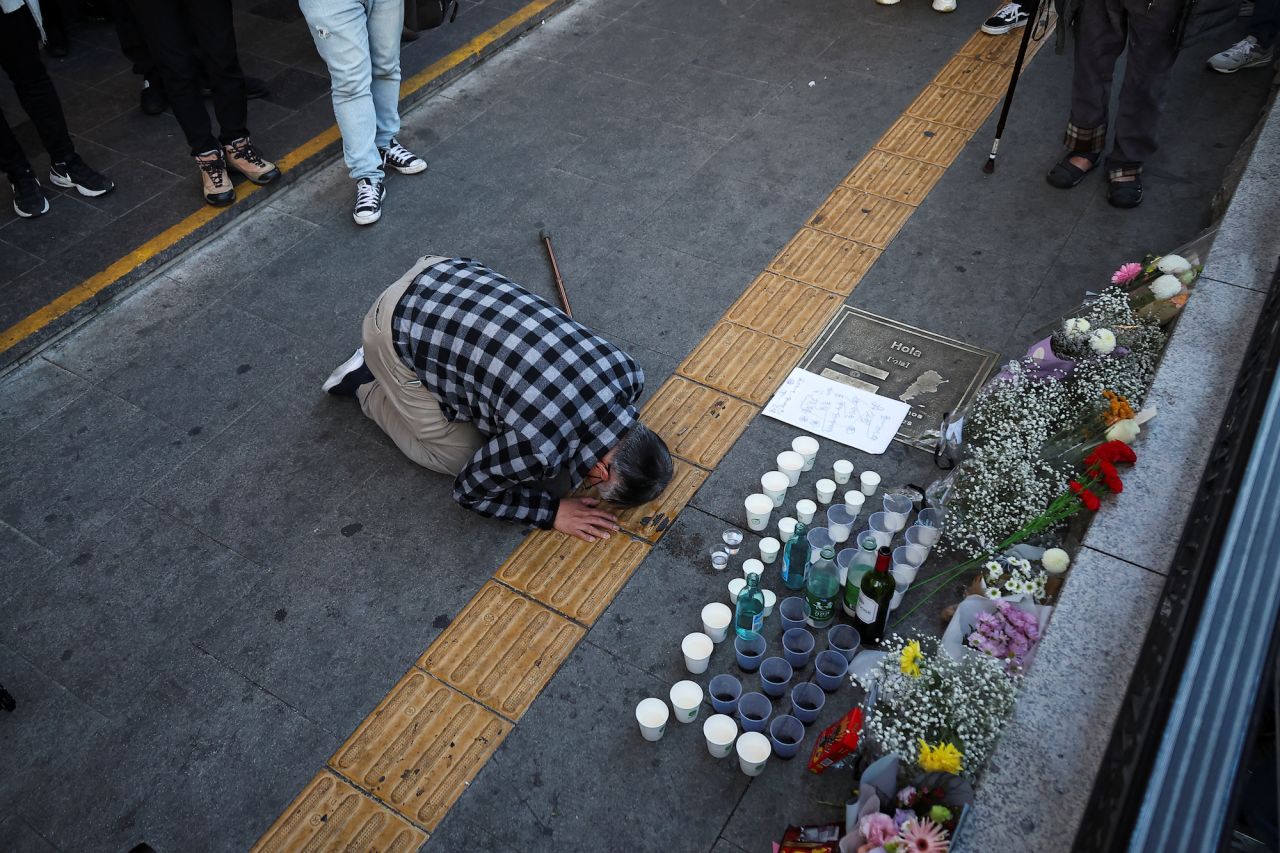 A person pays tribute near the scene of the crowd surge during Halloween festivities, in Seoul, on Sunday.