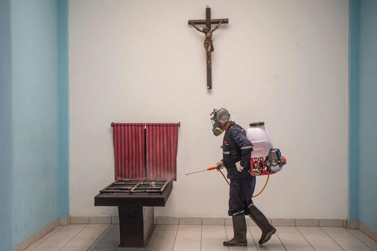 A worker disinfects an area of El Angel crematorium in Lima on May 21.