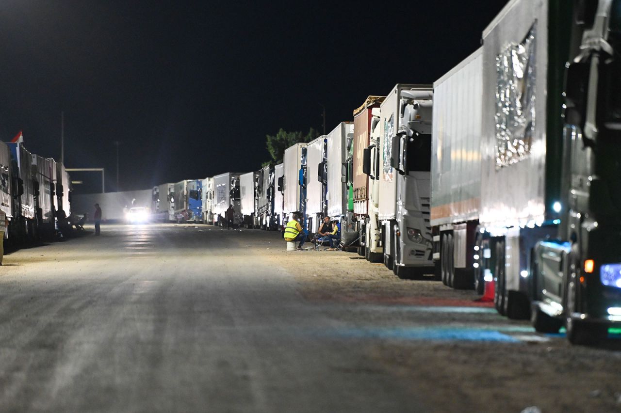 A convoy of trucks carrying aid supplies line up on the Egyptian side of the Rafah border crossing on October 20.