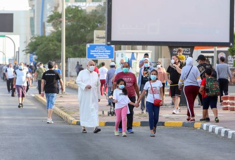 Residents walk in a neighborhood of Kuwait City, on May 12, as authorities allowed people to exercise for two hours under a nationwide lockdown due to the COVID-19 pandemic. 