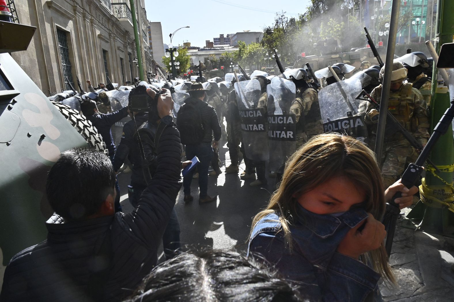 A woman walks away from tear gas fired by military troops in La Paz, Bolivia, on Wednesday, June 25. <a href="index.php?page=&url=https%3A%2F%2Fwww.cnn.com%2F2024%2F06%2F26%2Famericas%2Fbolivia-coup-attempt-claims-intl-latam%2Findex.html">A Bolivian general was arrested and accused of mounting a coup against the government</a> after attempting to storm the presidential palace on Wednesday.