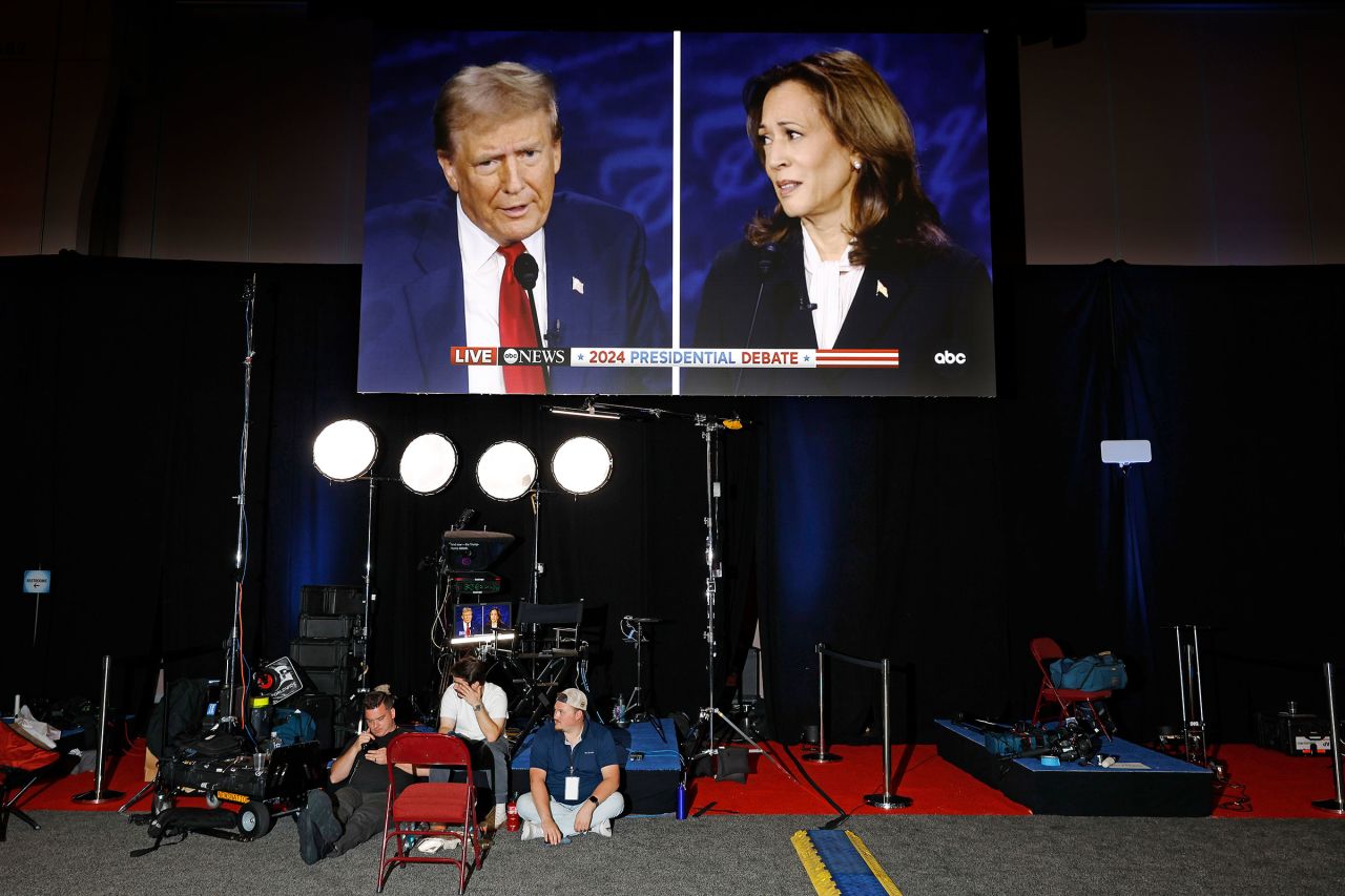 Donald Trump and Kamala Harris are seen on screens in the media center at the Pennsylvania Convention Center on September 10 in Philadelphia.