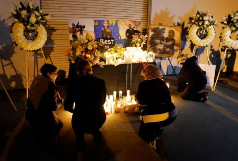 Attendees kneel at a candlelight vigil for the late cinematographer Halyna Hutchins on October 24 in Burbank, California. 