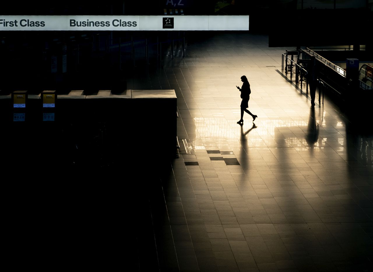 A passenger walks through an almost deserted terminal at the airport in Frankfurt, Germany, on Wednesday, March 18.