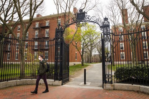 A pedestrian wearing a protective mask exits Harvard Yard on the closed Harvard University campus in Cambridge, Massachusetts, on April 20.