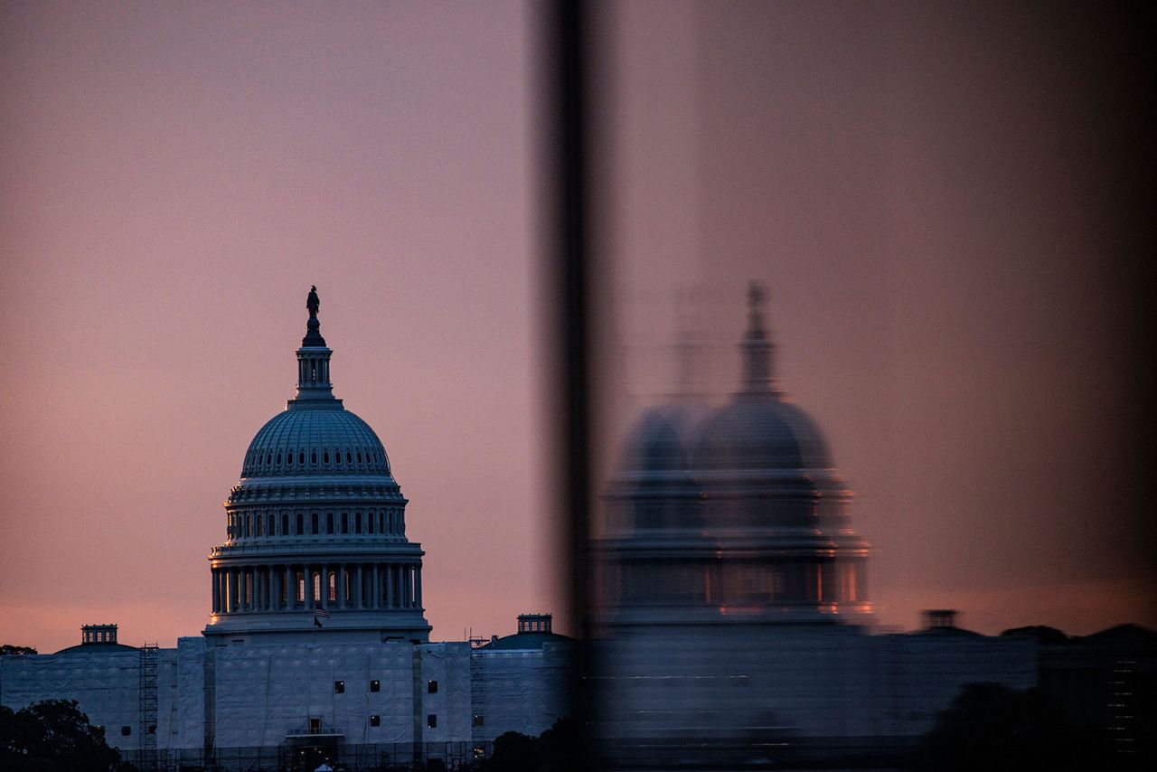 The US Capitol building is seen from the base of the Washington Monument as the sun rises in Washington, DC, on May 28.