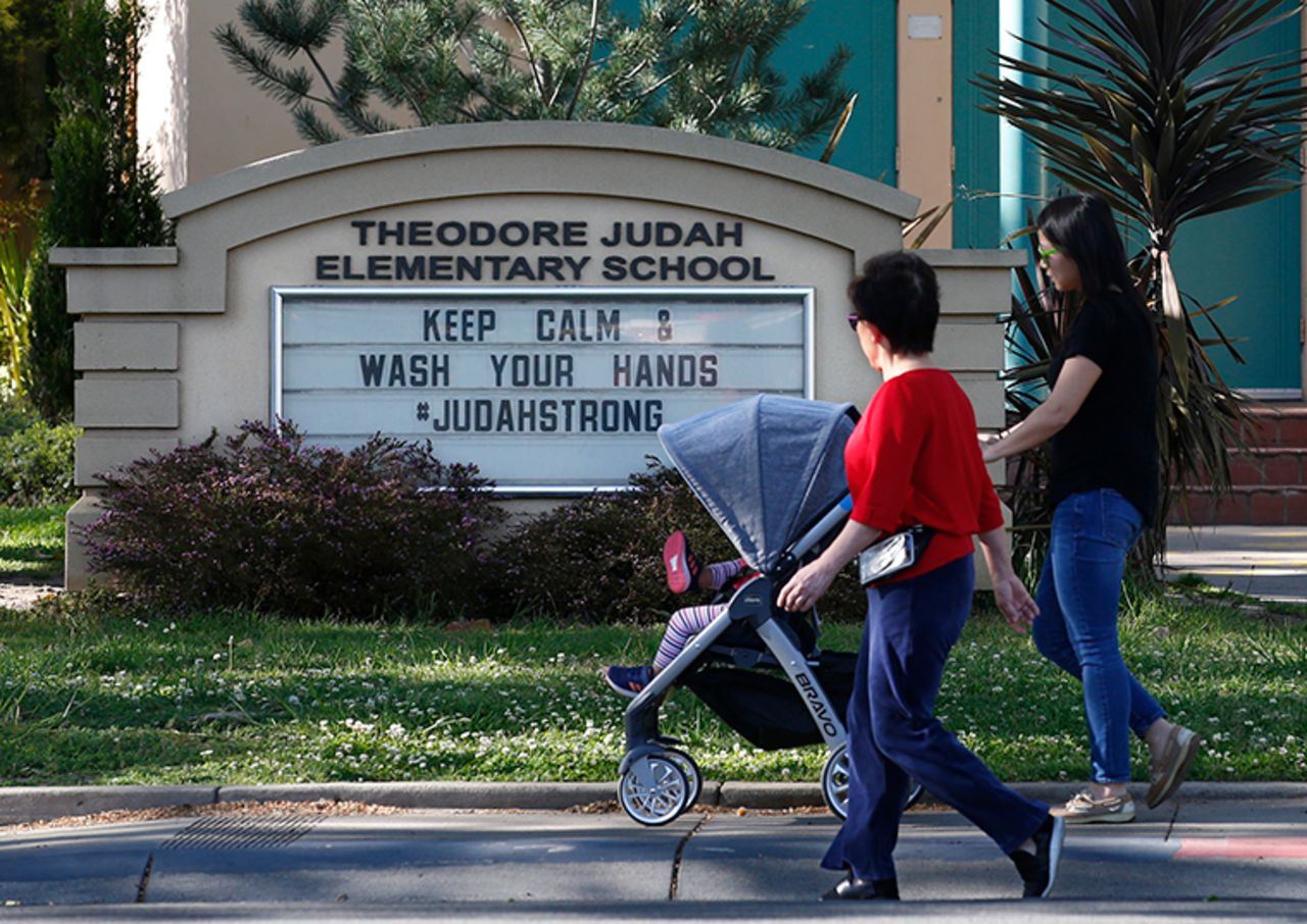 A reminder for people to wash their hands is displayed on a sign outside Theodore Judah Elementary School in Sacramento, California on April 1.