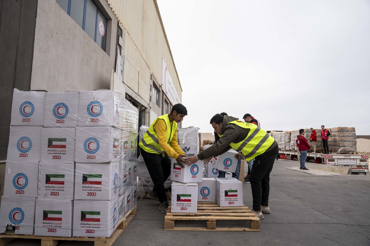 Members of the Egyptian Red Crescent and civil organizations work to mobilize aid in preparation for its entry into Gaza on January 17 in Rafah, Egypt.