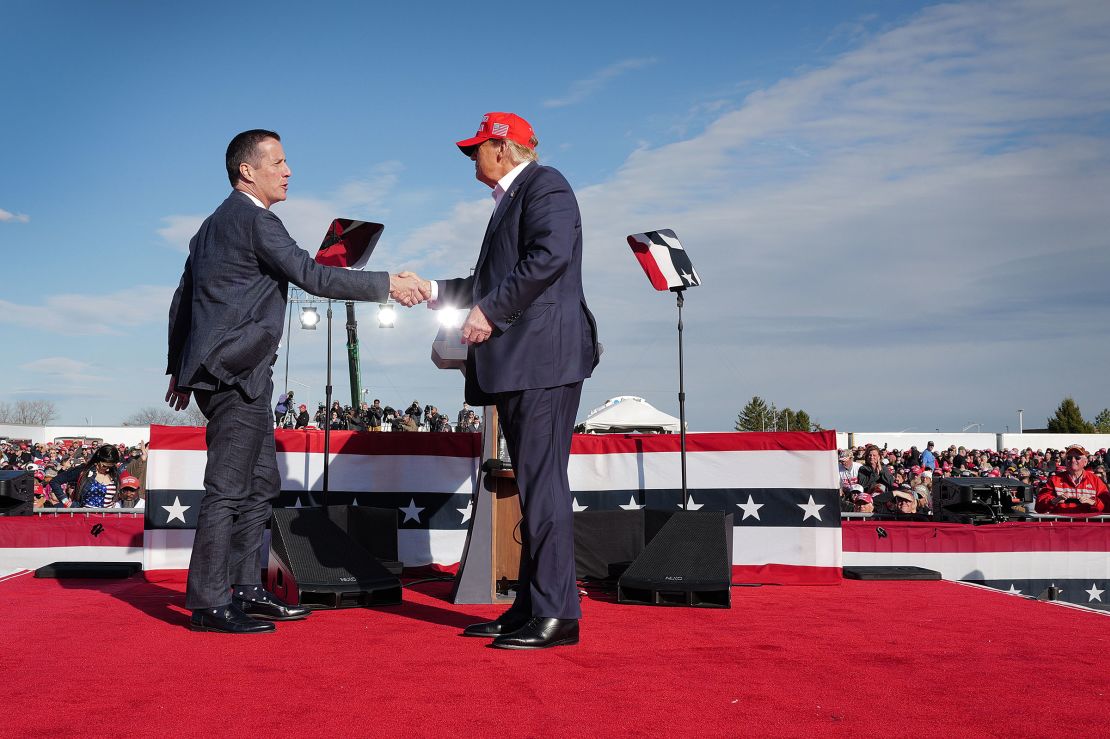 Republican presidential candidate former President Donald Trump greets Ohio Republican candidate for US Senate Bernie Moreno during a rally at the Dayton International Airport on March 16, in Vandalia, Ohio.