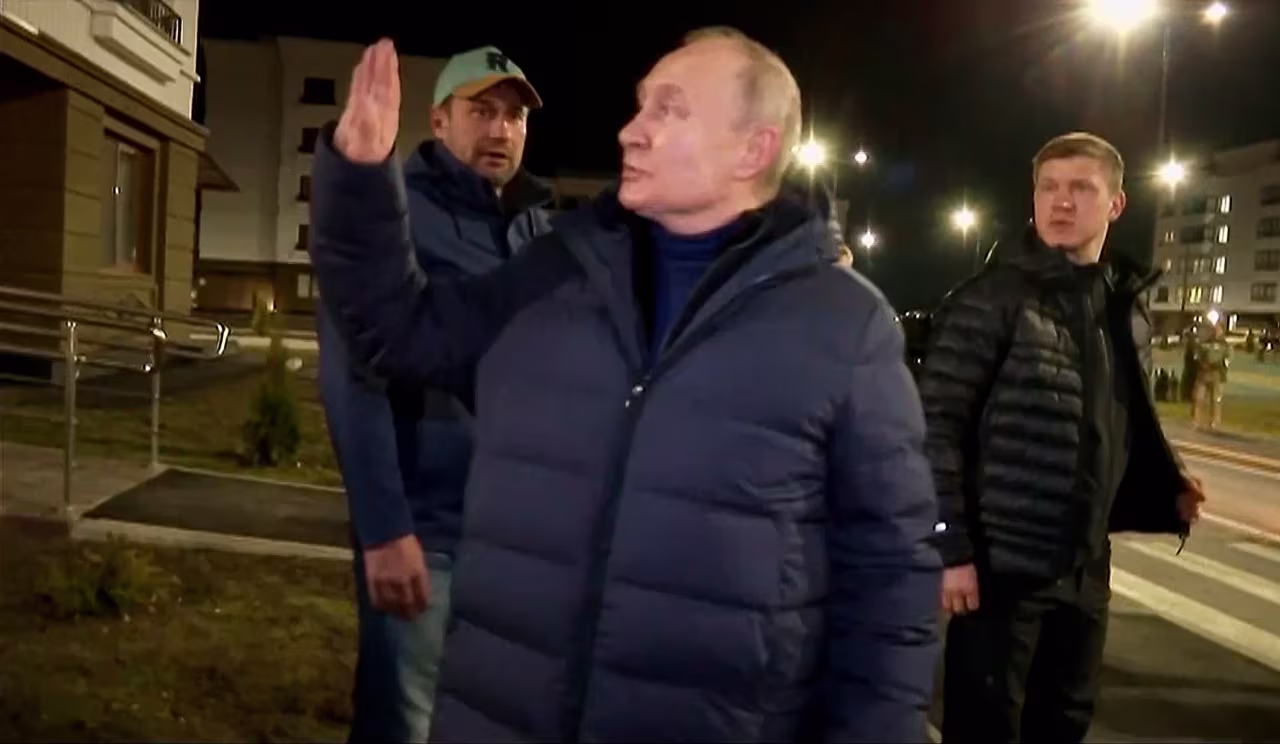 Russian President Vladimir Putin waves to residents in Mariupol, Ukraine, in a video released on March 19. 