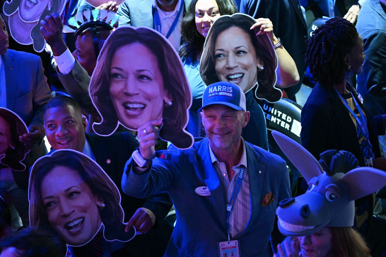 Attendees hold up signs on the second night of the DNC on Tuesday, August 20, in Chicago.