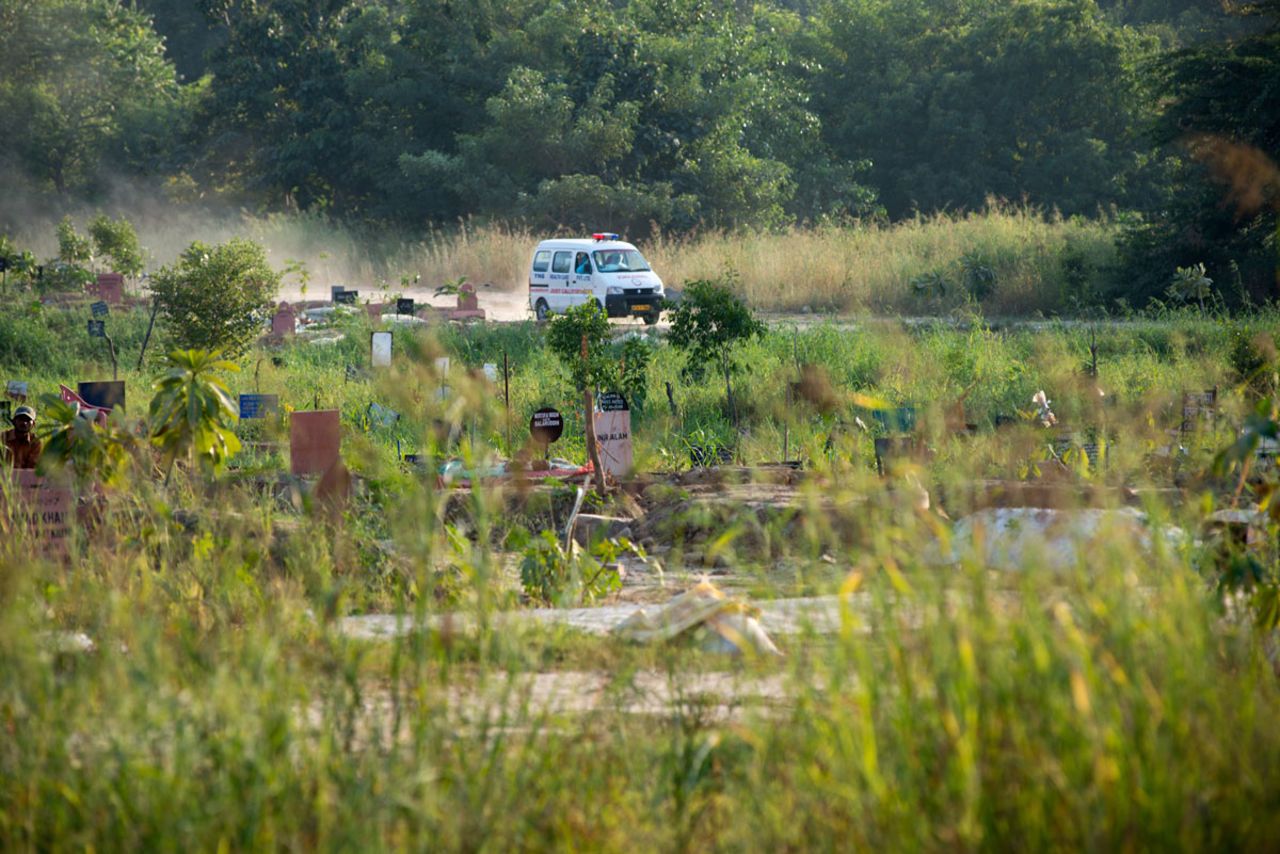 An ambulance carrying bodies of men who died from the coronavirus arrives at a graveyard in New Delhi, India on October 7. The country has the third highest number of coronavirus-related deaths, behind the United States and Brazil.