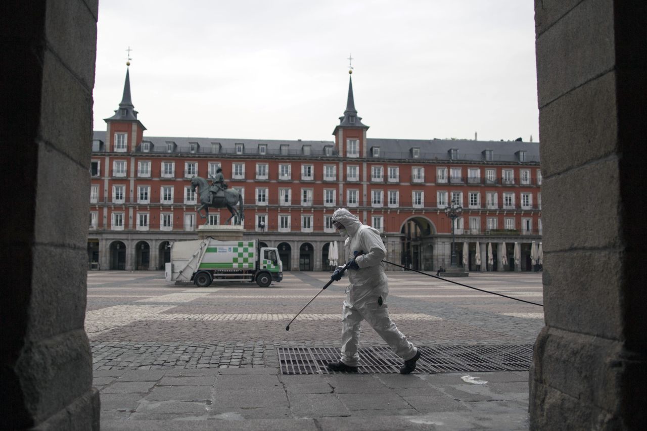 A worker cleans the pavement of Plaza Mayor square in Madrid, Spain, on March 18.