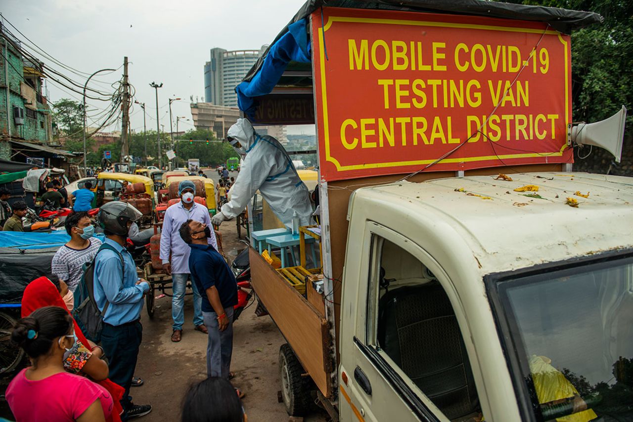 A health worker on a mobile testing van takes a nasal swab from a man in New Delhi, India on August 5.