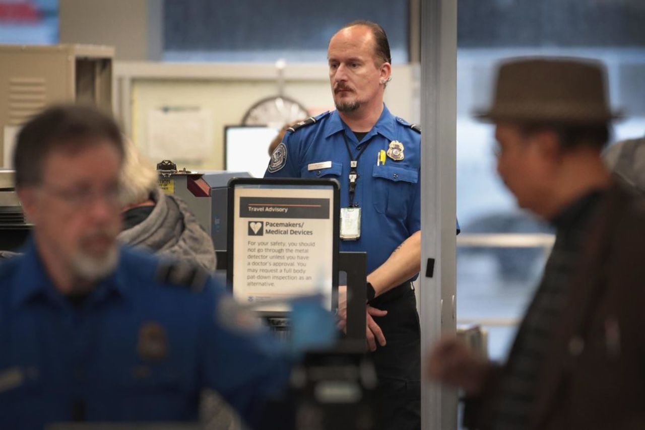 A Transportation Security Administration worker screens passengers and airport employees at O'Hare International Airport on Jan. 07, 2019 in Chicago, Illinois. 