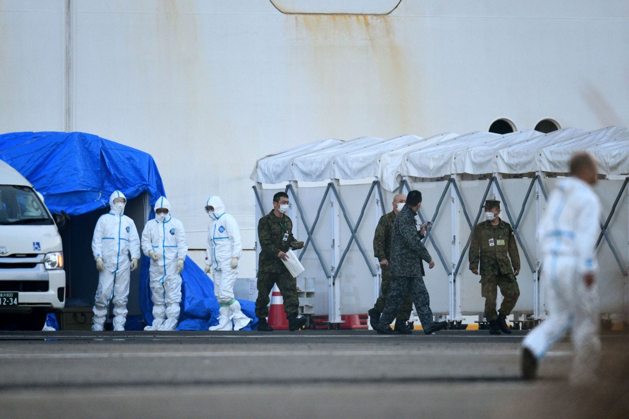 Medical staff and military personnel are seen near the quarantined Diamond Princess cruise ship on February 13. 