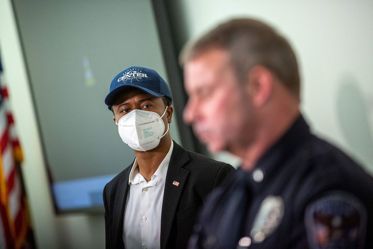 Brooklyn Center Mayor Mike Elliott, left, looks on during a press conference on Monday, April 12.