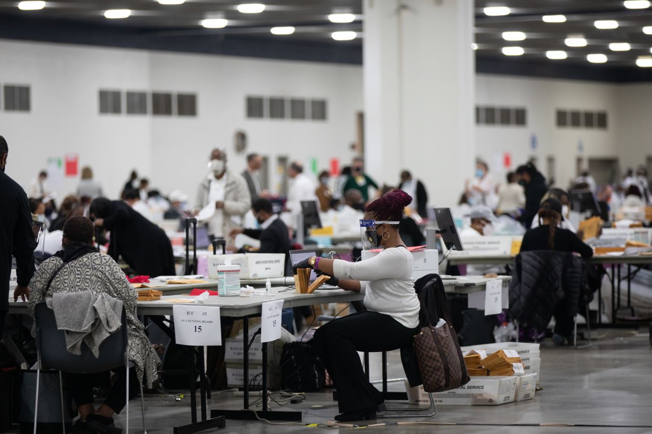 Volunteers wearing protective masks process absentee ballots for the 2020 Presidential election at the TCF Center in Detroit, Michigan on Nov. 3, 2020. 