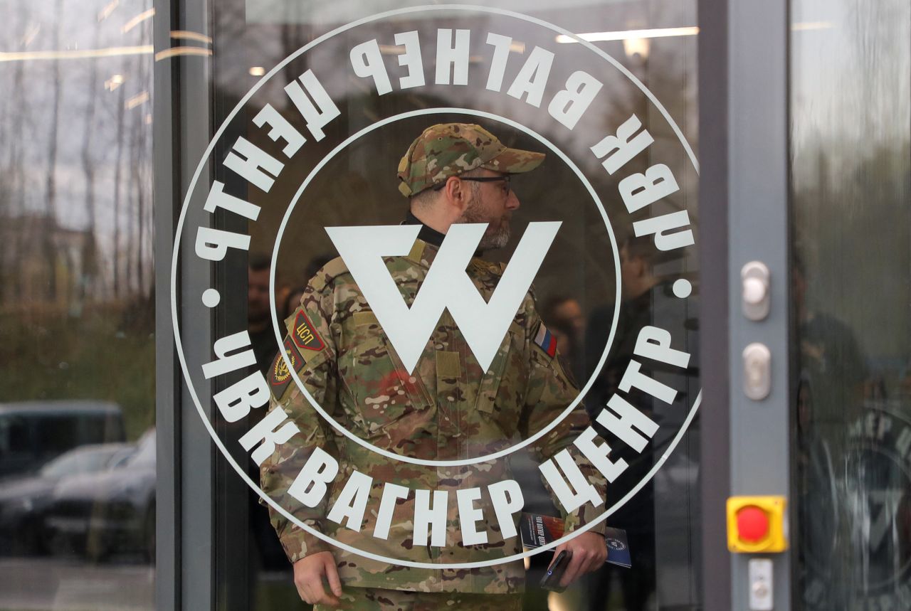 A man wearing a camouflage uniform walks out of PMC Wagner Center during the official opening of the office block in Saint Petersburg, Russia, on November 4, 2022. 