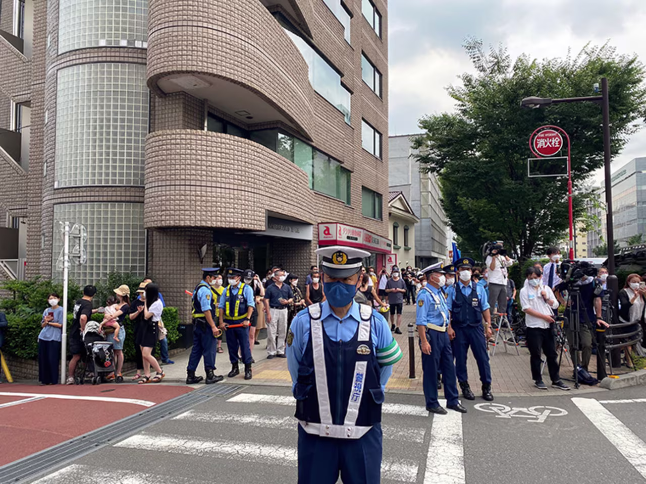 Police officers stand guard near the Abe family home in Tokyo on Saturday.
