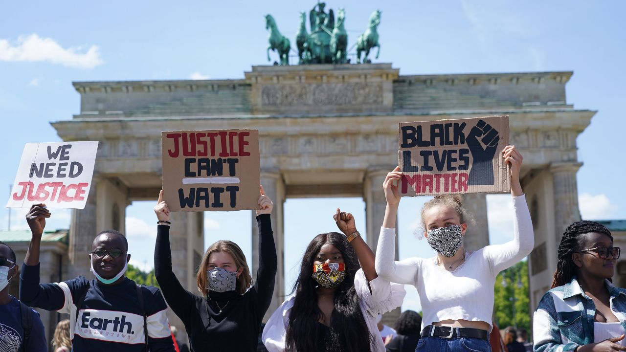 People participate in a protest in front of the Brandenburg Gate in Berlin on May 31.