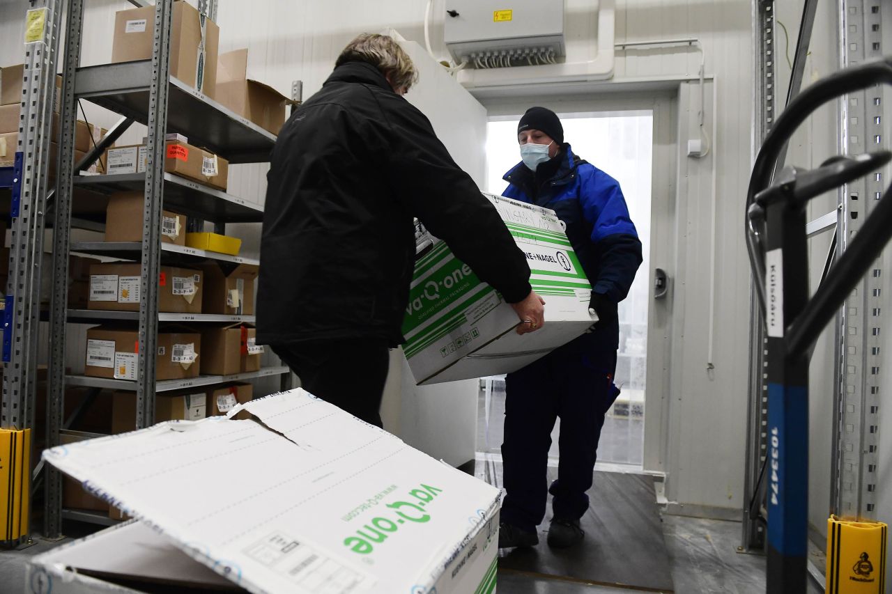 Men carry a box containing the Moderna COVID-19 vaccine as the first shipment of it arrived in Budapest, Hungary, on January 12.