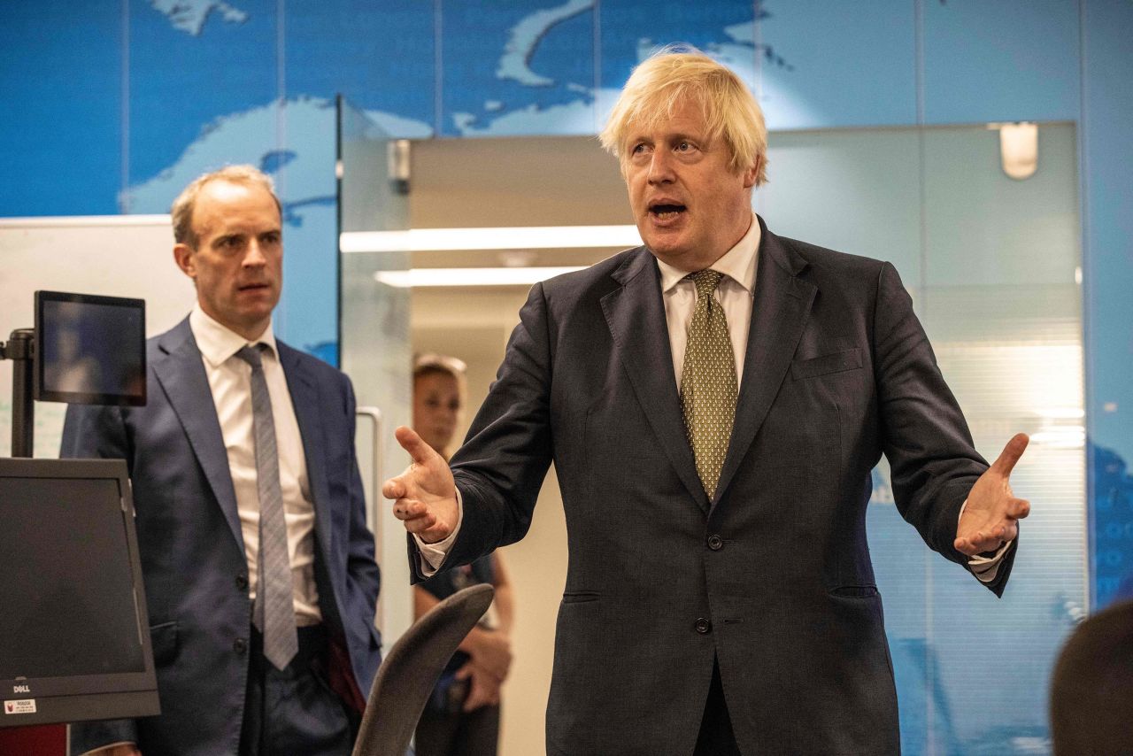 Britain's Prime Minister Boris Johnson (right) and Britain's Foreign Secretary Dominic Raab (left) visit the Foreign, Commonwealth and Development Office Crisis Centre in London, on August 27, to see how they are supporting and monitoring the ongoing evacuations in Afghanistan.