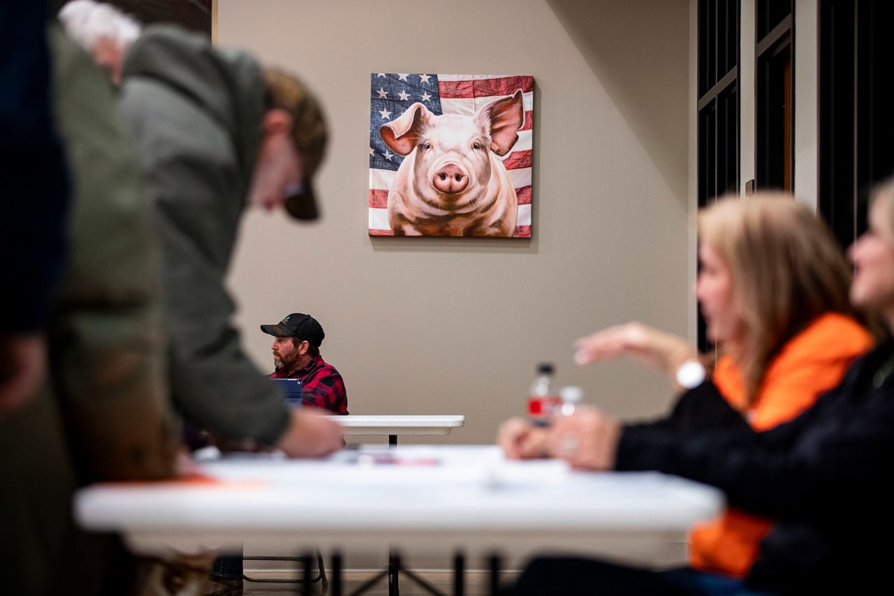 Caucusgoers sign in at Stutsman's Agricultural Products and Services in Hills, Iowa.