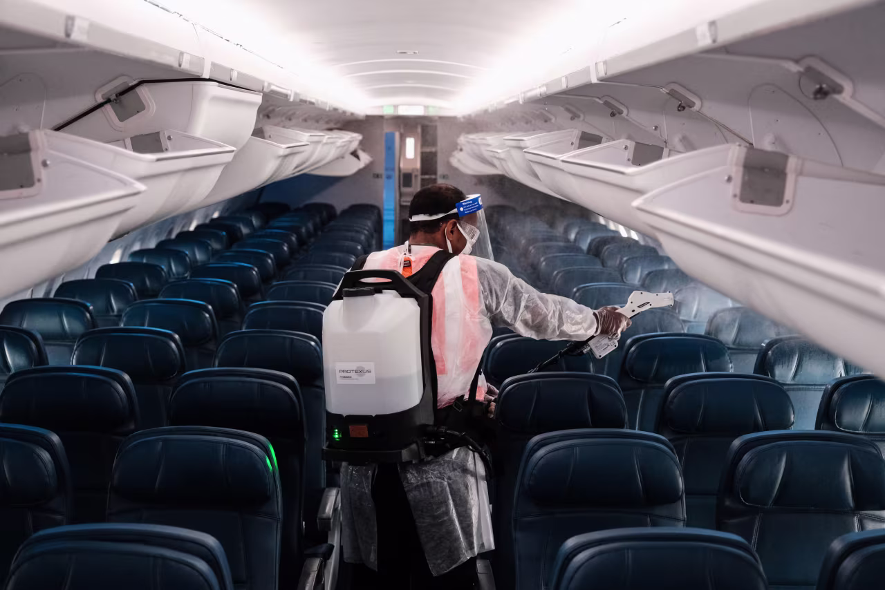 An airport employee performs an aircraft disinfecting demonstration during a media preview at the Ronald Reagan National Airport on July 22.