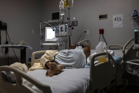 A patient is seen lying on a bed in the COVID-19 intensive care unit at the United Memorial Medical Center on January 1 in Houston, Texas. 