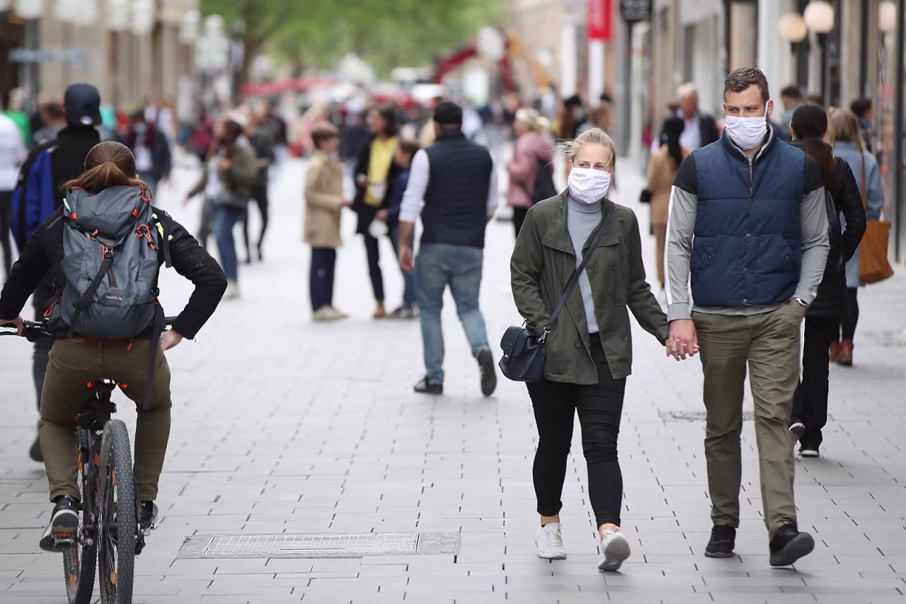 People wearing protective face masks walk on the main shopping street in Munich City during the coronavirus crisis on April 30, in Munich, Germany.