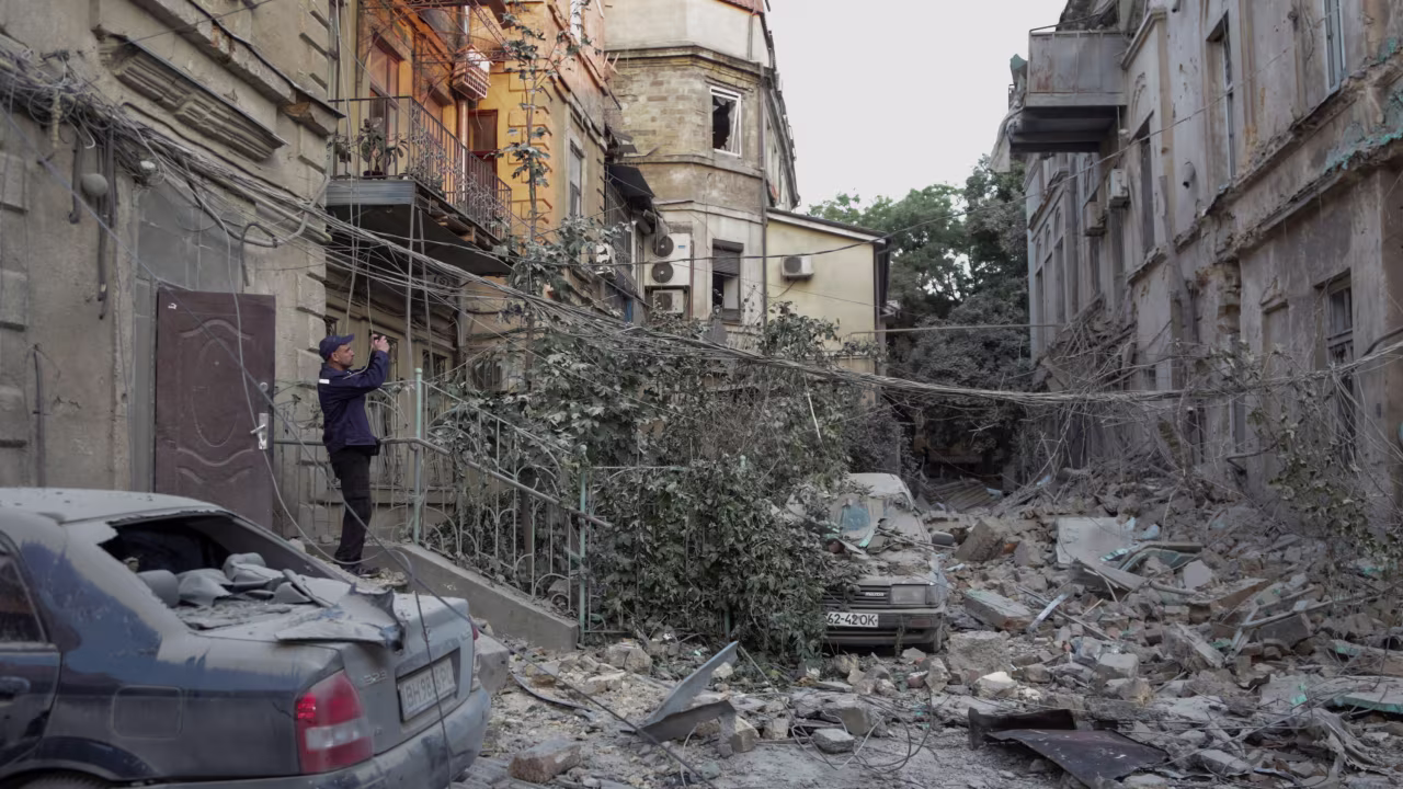 A rescuer takes a picture of a residential building damaged during a Russian missile strike in Odesa, Ukraine, on July 23, 2023.