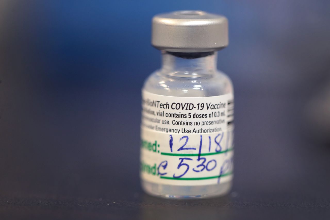 A container of five doses of Covid-19 vaccine sits on a table as workers continue to distribute the vaccine to staff at Roseland Community Hospital on December 18, in Chicago, Illinois.