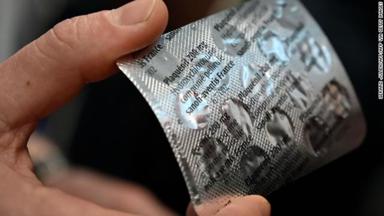 Medical staff show a packet of Plaqeril tablets containing hydroxychloroquine on February 26 at the IHU Mediterranee Infection Institute in Marseille, France. 