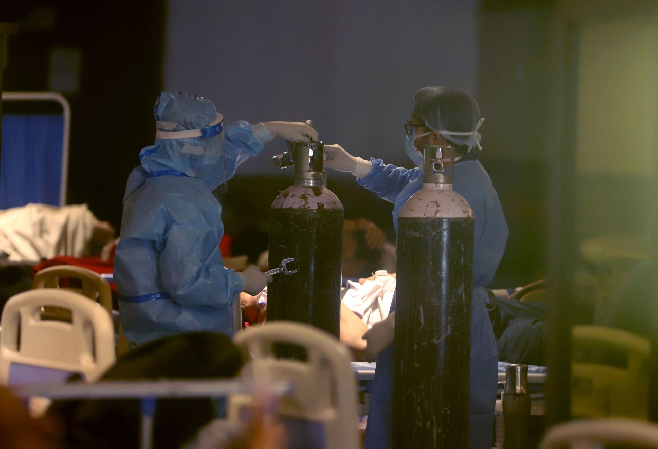 Health workers install oxygen cylinders for Covid-19 patients at a makeshift hospital in New Delhi on April 30.