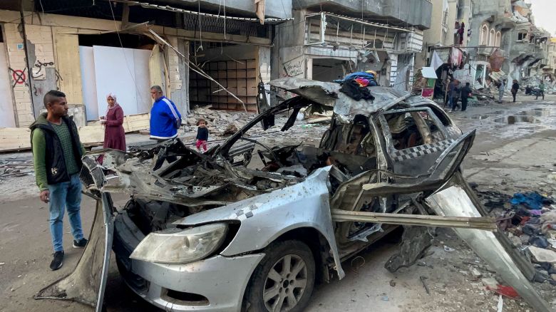 People look at the car in which three sons of Hamas leader Ismail Haniyeh were reportedly killed in an Israeli air strike near Al Shati, northwest of Gaza City, on April 10. 