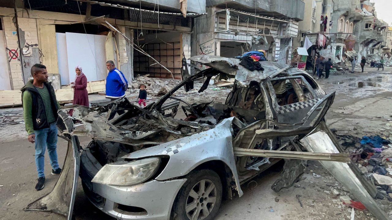 People look at the car in which three sons of Hamas leader Ismail Haniyeh were reportedly killed in an Israeli air strike near Al Shati, northwest of Gaza City, on April 10. 