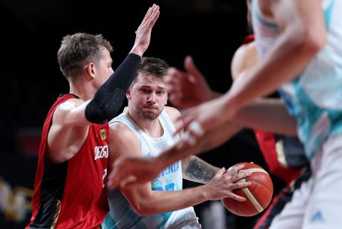 Slovenia's Luka Doncic dribbles past German players in the men's quarter-finals match on Tuesday.