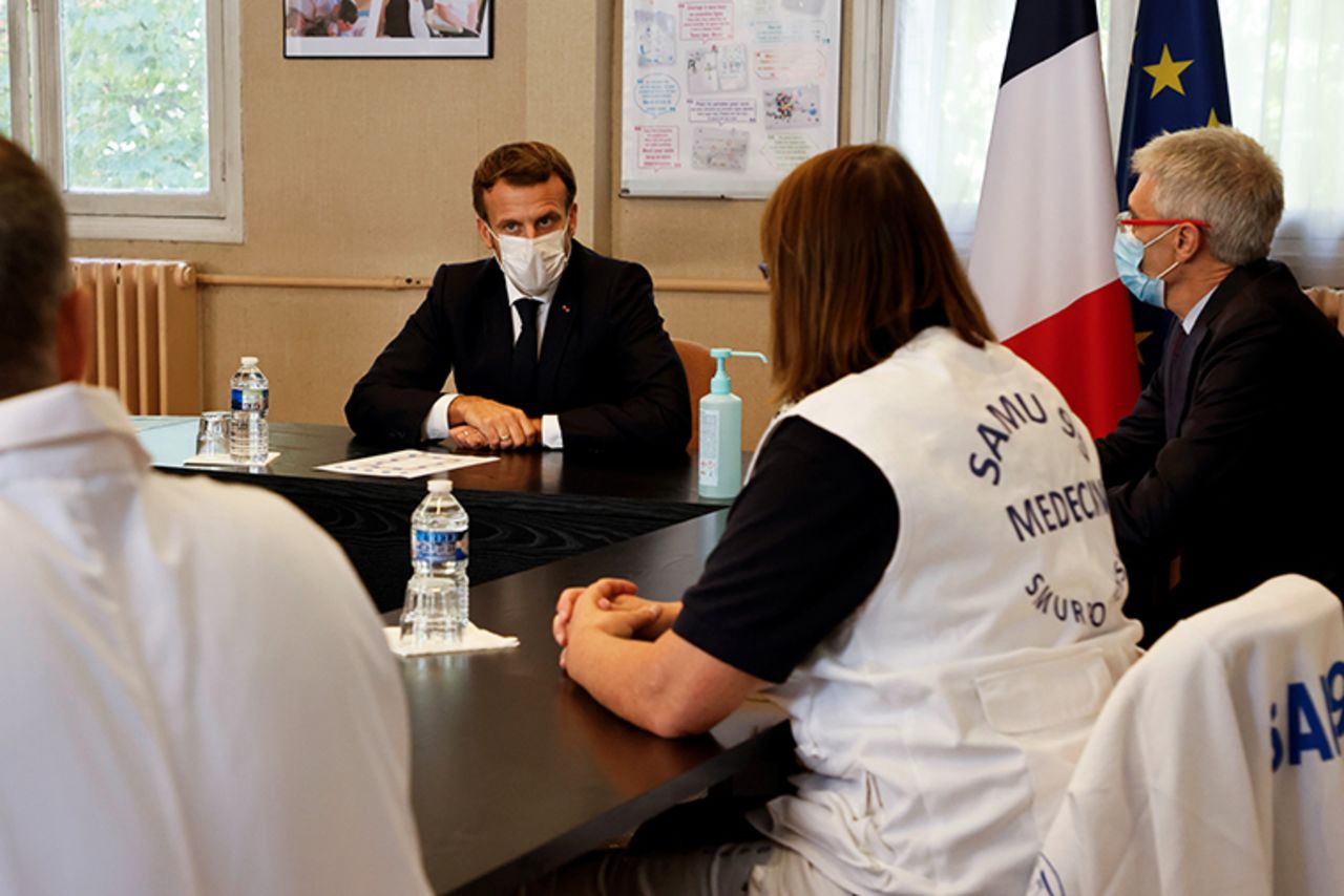 French President Emmanuel Macron (2nd L) chairs a meeting with the medical staff of the René Dubos hospital center, in Pontoise, in the Val d'Oise, on October 23, 2020, as the country faces a new wave of infections to the Covid-19.