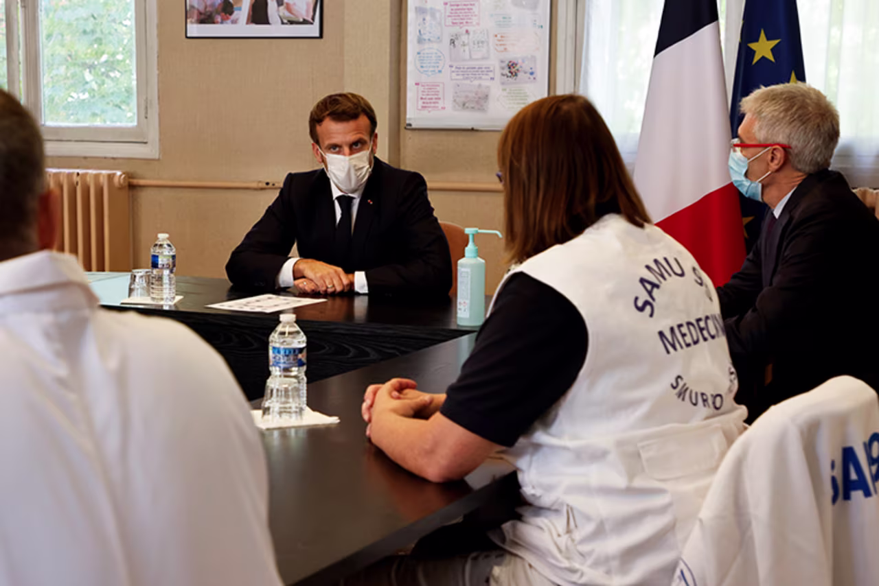 French President Emmanuel Macron (2nd L) chairs a meeting with the medical staff of the René Dubos hospital center, in Pontoise, in the Val d'Oise, on October 23, 2020, as the country faces a new wave of infections to the Covid-19.