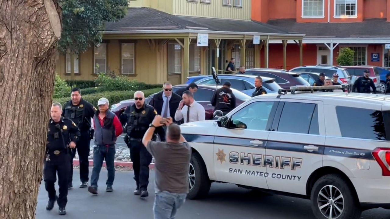 Police officers detain a man, believed by law enforcement to be the Half Moon Bay mass shooting suspect, in Half Moon Bay, California, on January 23.