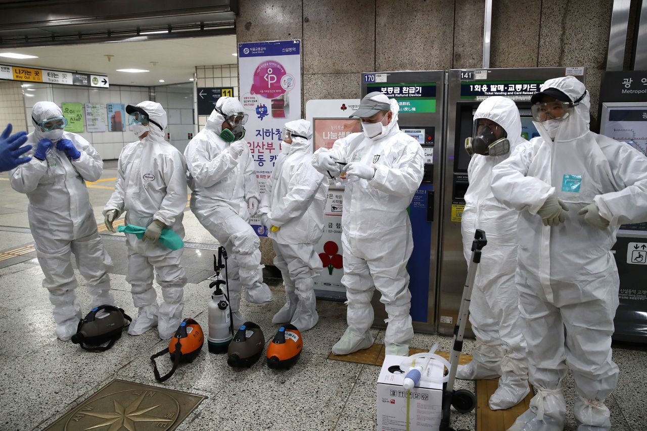 Workers prepare to disinfect a subway station in Seoul on Friday.