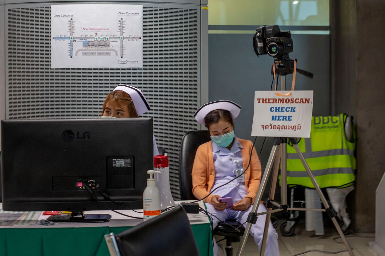 Thai public health officers operate a health checkpoint with a thermo scan at Suvarnabhumi International airport in Bangkok.