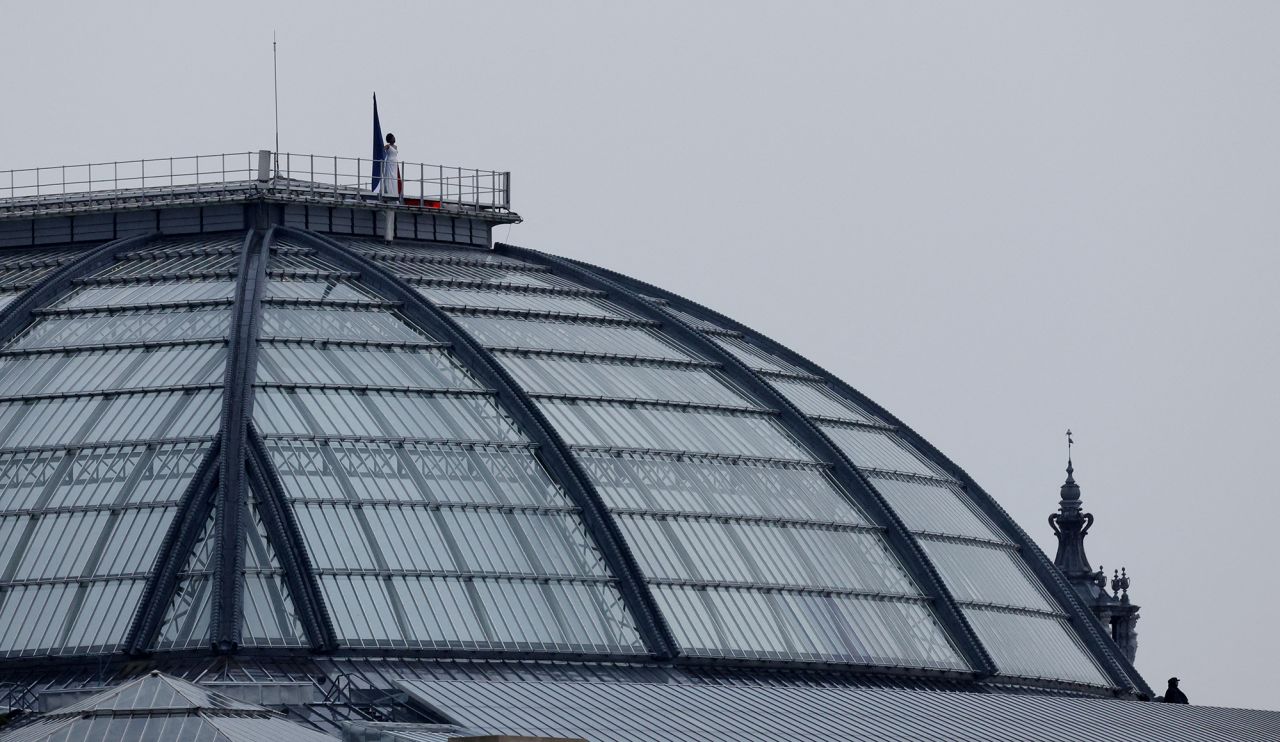 Axelle Saint-Cirel is seen performing The Marseillaise on the roof of the Grand-Palais.