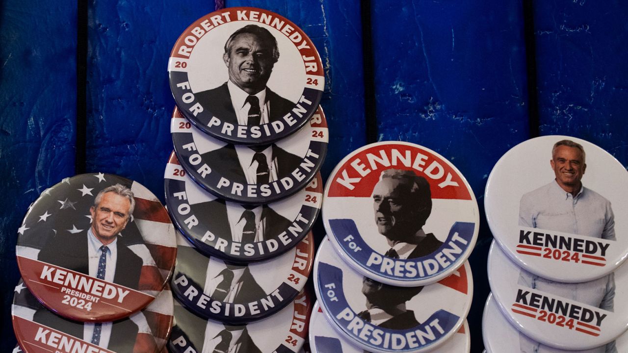 Pins and other merchandise in support of Independent presidential candidate Robert F. Kennedy Jr. on display during a voter rally at St. Cecilia Music Center on February 10 in Grand Rapids, Michigan.